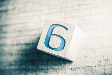 Number 6 On A Wooden Block On A Table