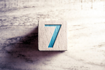 Number 7 On A Wooden Block On A Table