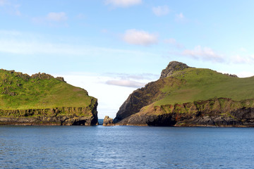 Fototapeta premium Green islands at sea in Scotland, United Kingdom.
