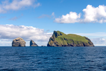 Fototapeta na wymiar Green islands at sea in Scotland, United Kingdom.
