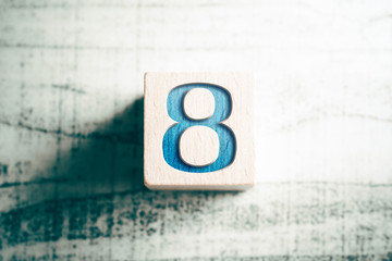 Number 8 On A Wooden Block On A Table