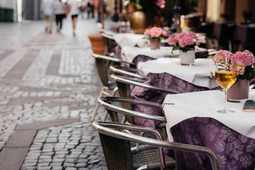 A glass of wine on the table of a beautiful coffee shop in the center of Europe. Rest