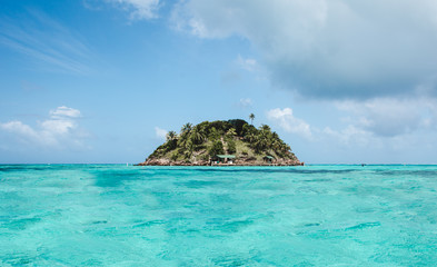 Intense turquoise water around Crab Cay, a small rock off Isla de Providencia, one of Colombia's...