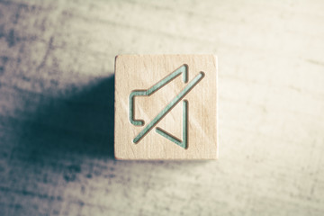 Volume Mute Icon On A Wooden Block On A Table