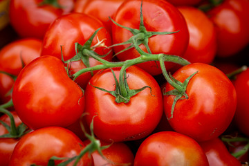 A full frame photograph of tomatoes for sale on a market stall
