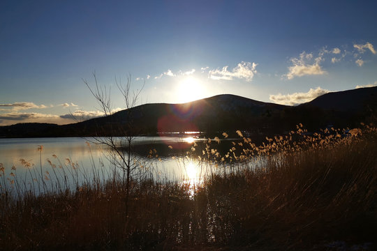 Mountain, Lake, Blue Sky And Sun In Japan Countryside At Sunset