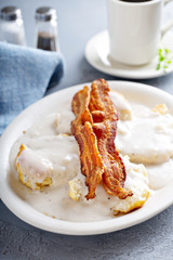 Biscuits and gravy with slices of bacon, southern breakfast