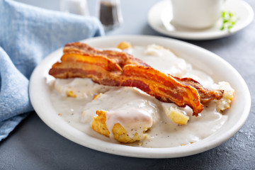 Biscuits and gravy with slices of bacon, southern breakfast