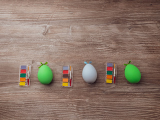 easter eggs and colorful paints and brushes