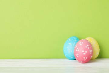 Easter eggs on white wooden table, space for text