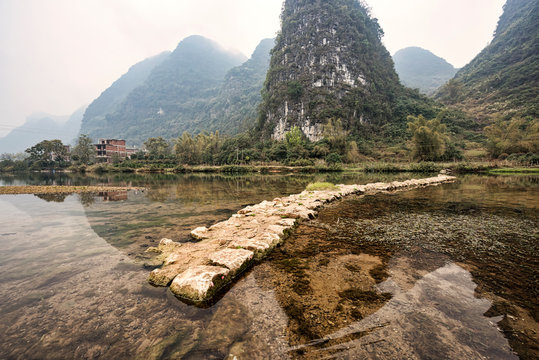Mountainous karst landscape in Guilin with rock walkway