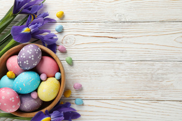 Composition with Easter eggs and Iris flowers on wooden background, space for text