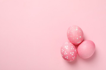 Fototapeta na wymiar Easter eggs on pink background, space for text