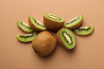 Ripe kiwi on craft brown background, top view
