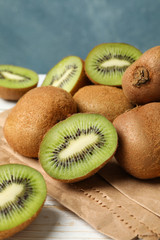 Craft paper with kiwi on wooden table, close up