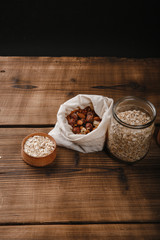 Nuts and seeds in bags on wooden background.Zero waste concept.