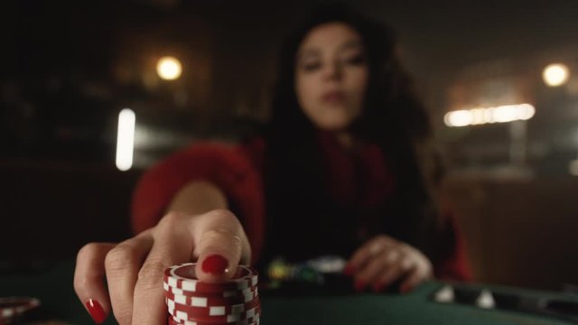 Woman with red nails playing poker