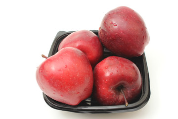 red apples in a black plate