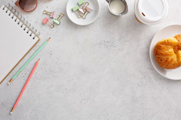 Clean and bright desk overhead feminine office tabletop background with copy space and a notebook