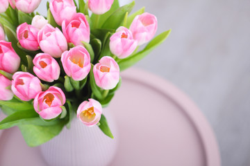 Pink tulips flowers bouquet in vase on table. Women, Mothers, Valentine's Day, birthday, spring greeting card. Copy space.