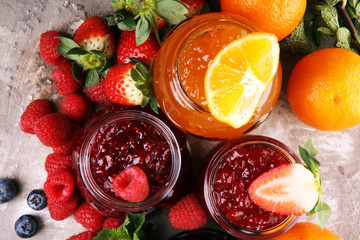 assortment of jams, seasonal berries jelly, mint and fruits and tangerine