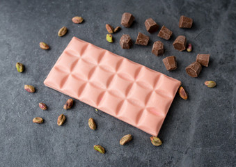pink chocolate on a background with nuts