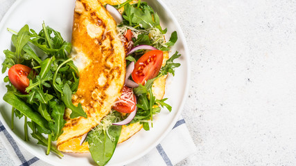 Omelette with green leaves top view.
