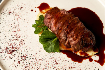 Filet mignon with mashed potatoes and pomegranate sauce, close-up