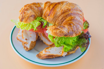 Sandwich of croissant of lettuce, tomato and smoked turkey