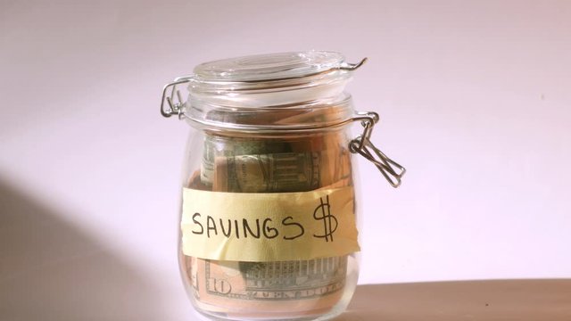 Put money into moneybox. Isolated savings jar on white background. Financial literacy concept. Personal financing 