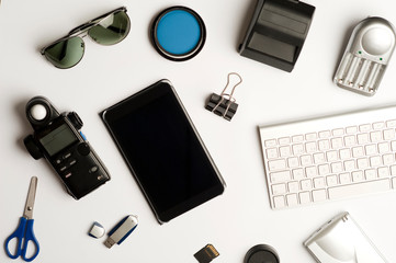 Flat assembly composition with photographic production equipment on plain white background, top view