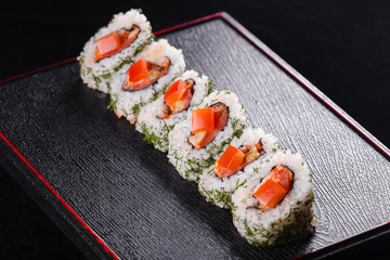 Japanese food, tasty of meal for lunch. Seafood. Sushi with eel, salmon, trout, tuna black background.
