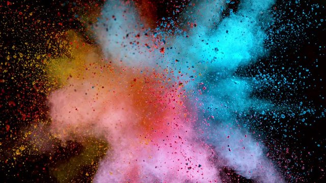 Colorful powder exploding on black background in super slow motion, close-up.
