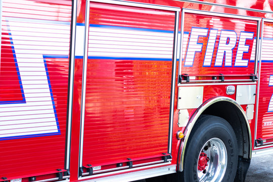 Coral Spring, FL / USA - 2/22/2020: Closeup of a red firetruck known as Engine 71 of the Coral Springs / Parkland Fire Department which includes a paramedic, extension ladder, water, hoses and lights 