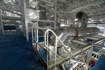 Ventilation pipes in the chemical production of mineral fertilizers in a lighted room.
