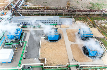 Blue industrial cooling tower at a chemical plant. Compressor station and pipeline. Top view.