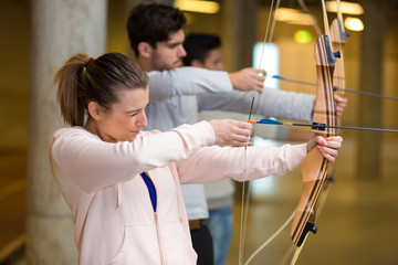 portrait of people during archery cours - obrazy, fototapety, plakaty