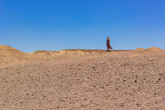 global warming climate changes concept landscape photography of lonely female person in the middle of desert scenic dry ground outdoor wilderness environment space