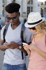 couple tourist backpackers using phone to find location