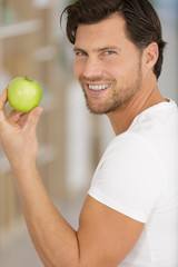 man with a green apple