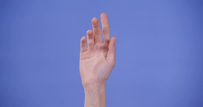 Woman showing A letter on blue ack background, closeup. Sign language