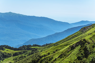 View over the Green Valley, surrounded by high mountains on a clear summer day