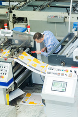 man worker near printing machine