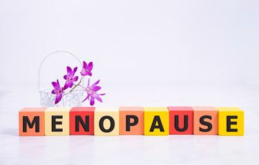 menopause word written on wood block. menopause text on table, concept