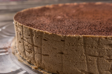 close-up of tiramisu cake with chocolate powder on a rustic table table
