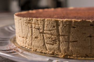 close-up of tiramisu cake with chocolate powder on a rustic table table