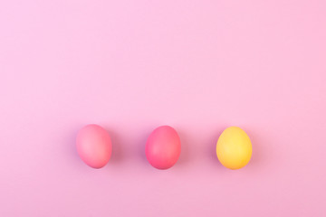 Easter eggs on pink background. Copyspace. Flat lay.