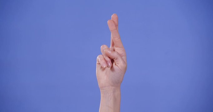 Woman showing R letter on blue background, closeup. Sign language