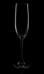Empty champagne glass on a black background, elegantly illuminated on the sides. Concept, mysterious club life.