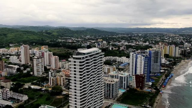 Aerial view of Tonsupa Beach in Ecuador, lots of buildings on a cloudy day